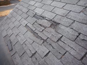 damaged asphalt shingles on a residential home in Northeast Ohio