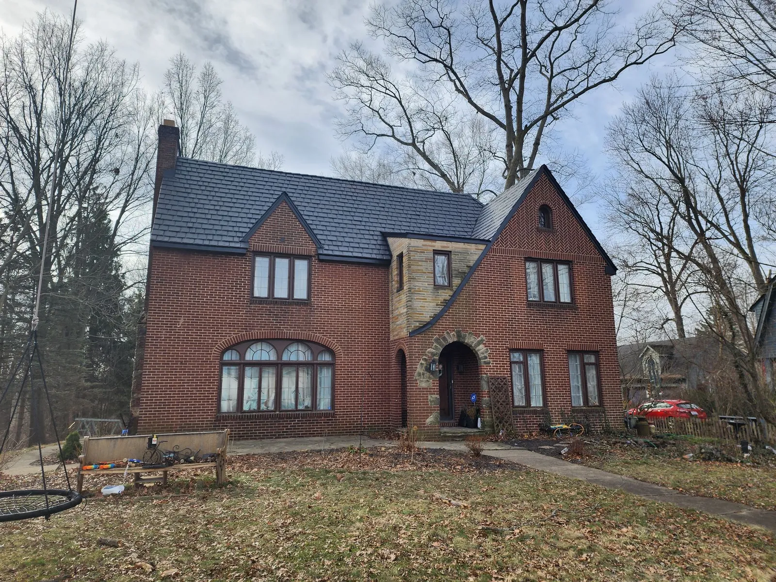 Completed asphalt shingle roof replacement on a brick home, highlighting outstanding craftsmanship, professional service, and a smooth customer experience.