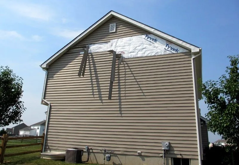 Wind damaged siding on a residential home in Jackson Township