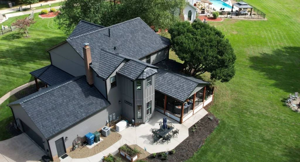 Aerial view of a large residential home with a Brava tile roof replacement completed by Hometown Roofing and Construction in Northeast Ohio