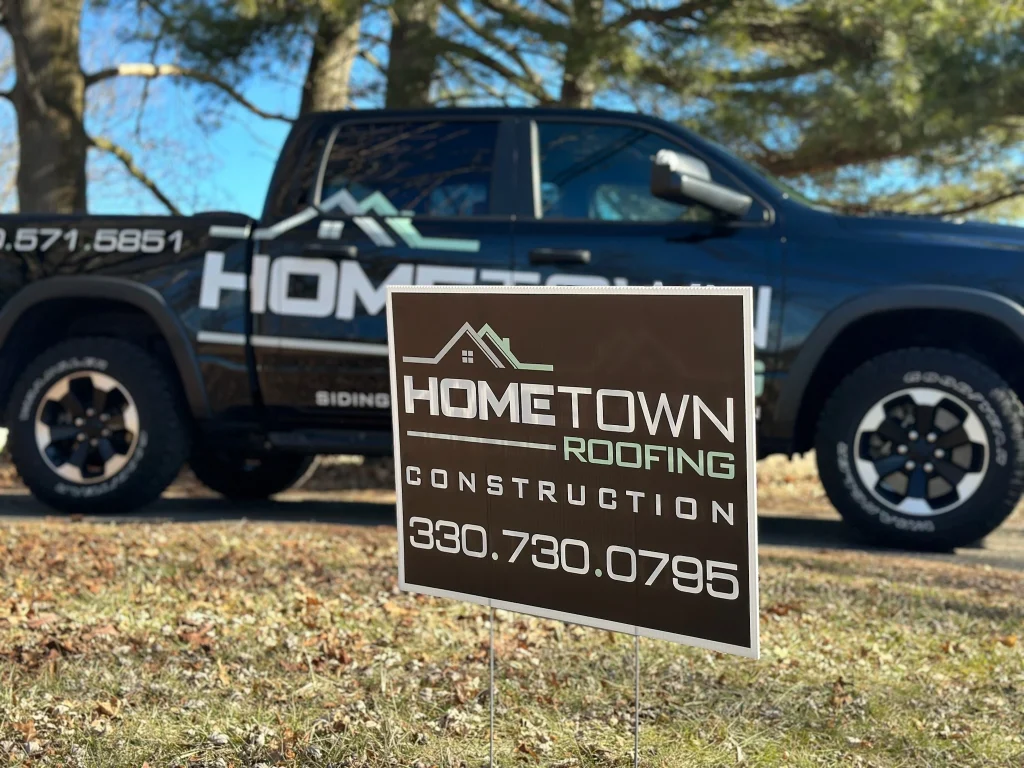 Hometown Roofing and Construction yard sign and branded truck at a residential roofing job site in Northeast Ohio 